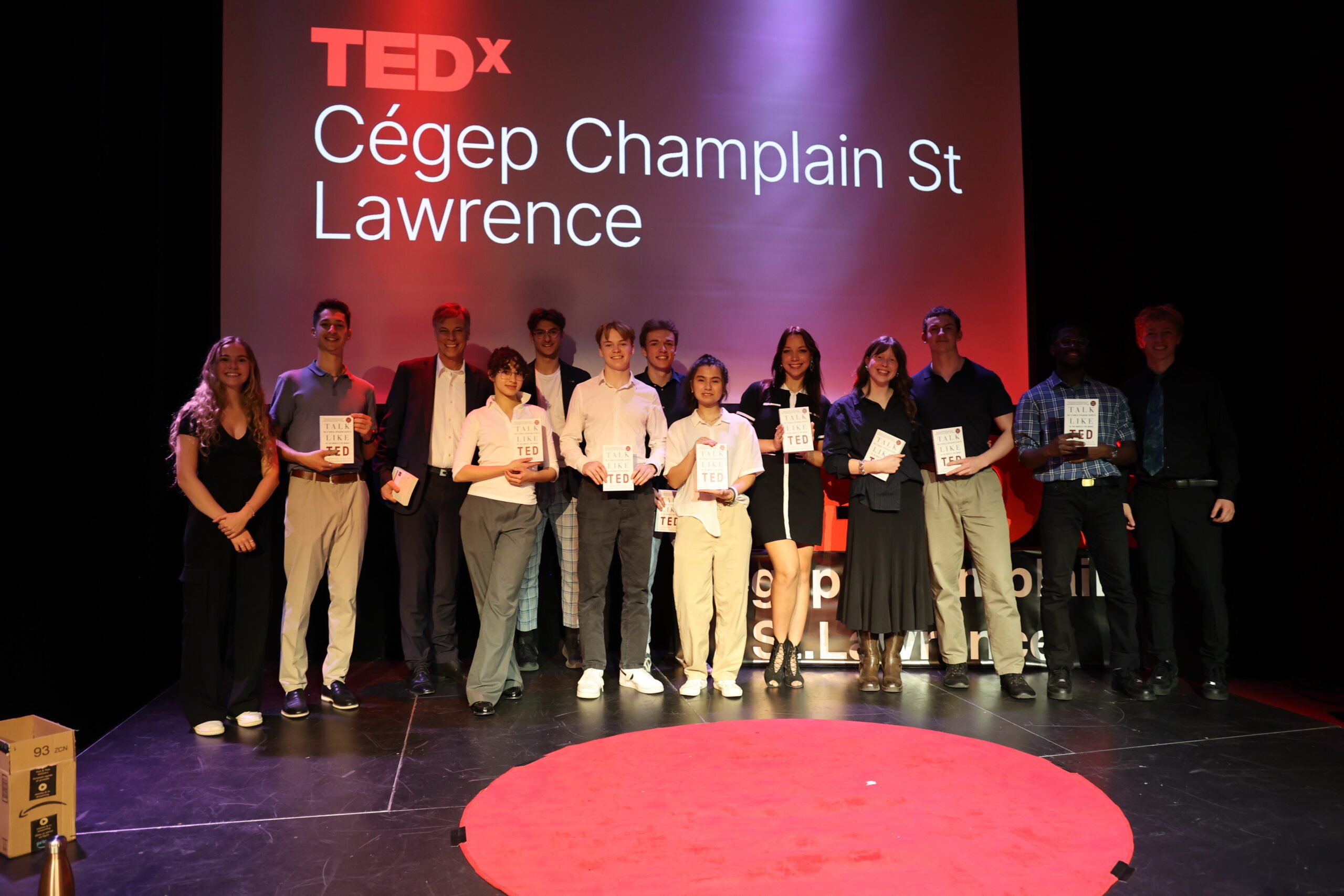 Students speakers pose with organizers to celebrate a successful event