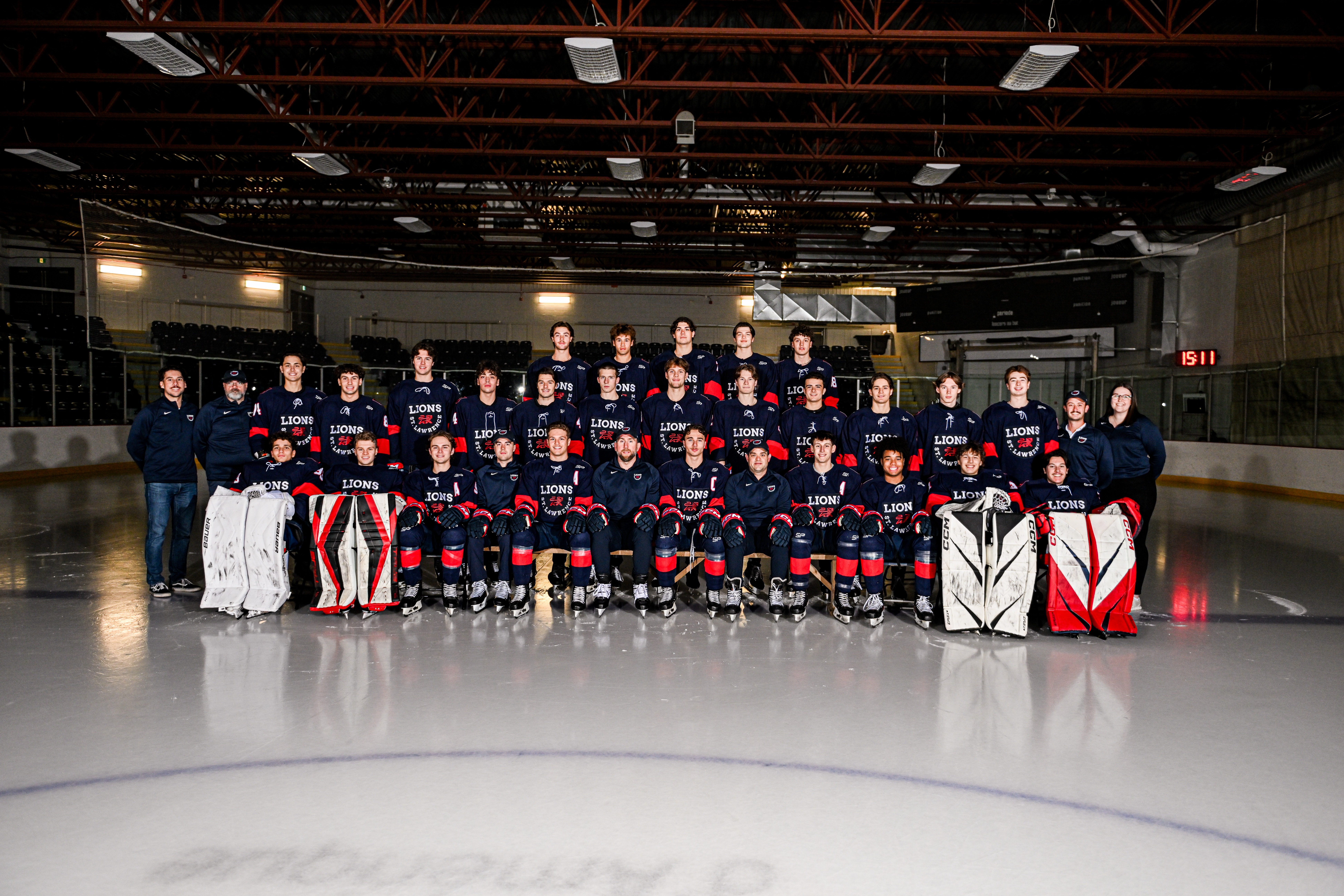 The men's 2025-2026 hockey team poses for a team photo on the ice