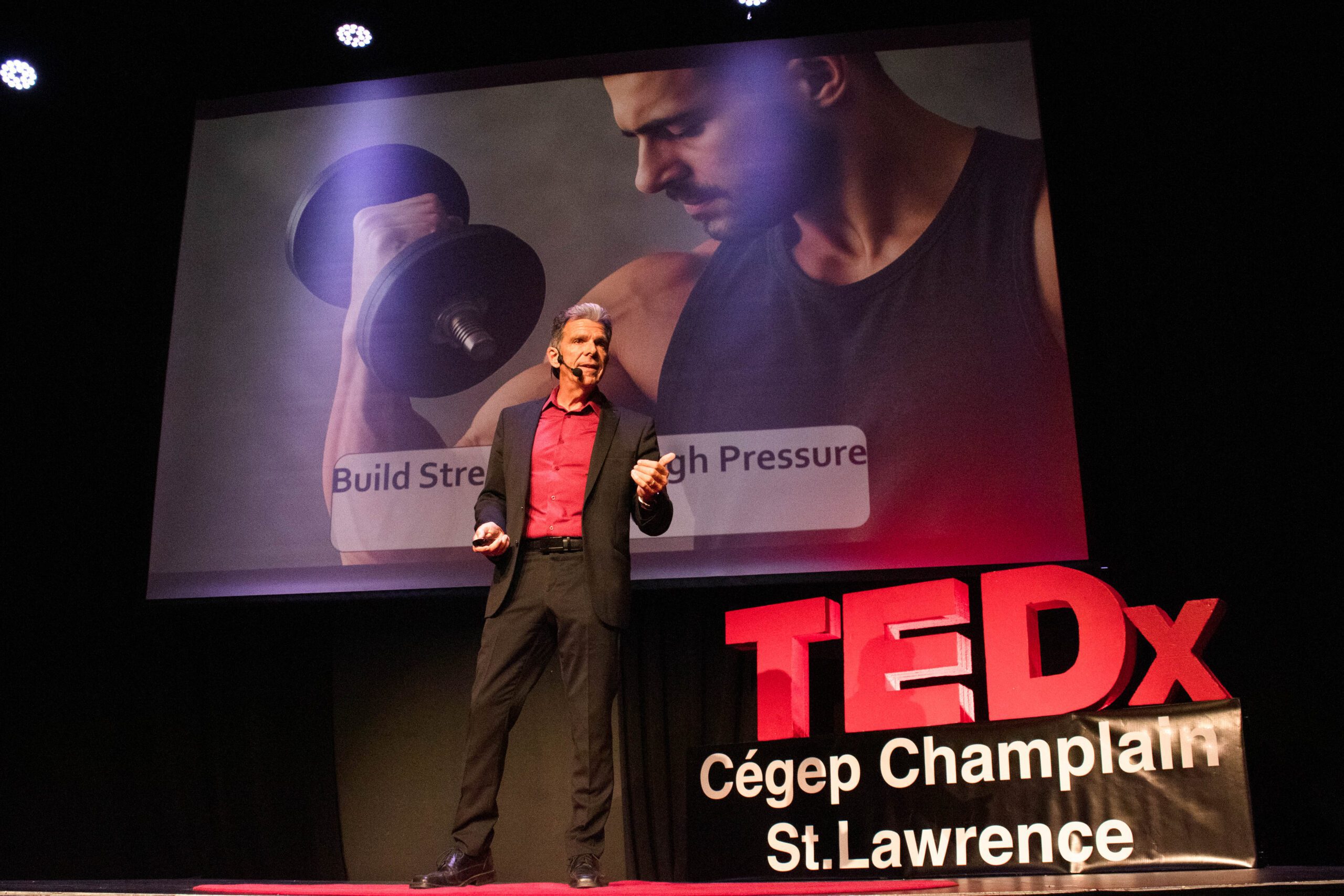 Guest speaker gives a talk in front of the TEDx sign